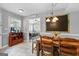 Eat-in kitchen dining area with a wood dining table and view to the Gathering room at 317 Calgary Dr, Peachtree City, GA 30269