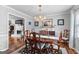 Traditional dining room with an elegant chandelier, beautiful artwork and hardwood flooring at 317 Calgary Dr, Peachtree City, GA 30269