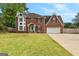 Charming two-story brick home with a well-manicured lawn and a delightful light blue front door at 317 Calgary Dr, Peachtree City, GA 30269