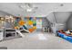 Spacious game room with unique geometric wall design, comfortable play areas, and playful decor at 317 Calgary Dr, Peachtree City, GA 30269
