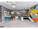 Versatile game room with colorful wall accents, unique decor, and space for creative play and activities at 317 Calgary Dr, Peachtree City, GA 30269