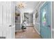Light-filled hallway featuring tile flooring, stylish decor, and a staircase leading upstairs at 317 Calgary Dr, Peachtree City, GA 30269