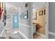 Inviting hallway with decorative lighting, tile flooring, and access to a stylish bathroom at 317 Calgary Dr, Peachtree City, GA 30269