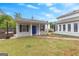 Charming home featuring a separate suite, blue front door, covered porch, and lush green lawn at 317 Calgary Dr, Peachtree City, GA 30269