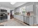 Eat-in kitchen featuring white cabinetry, stainless steel appliances, and tiled backsplash at 317 Calgary Dr, Peachtree City, GA 30269