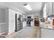 Eat-in kitchen featuring stainless steel appliances, white cabinetry and tile flooring at 317 Calgary Dr, Peachtree City, GA 30269