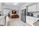 Eat-in kitchen featuring stainless steel appliances, white cabinetry and tile flooring at 317 Calgary Dr, Peachtree City, GA 30269