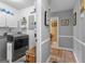 Bright laundry room features modern appliances, shelving and access to an interior hallway at 317 Calgary Dr, Peachtree City, GA 30269