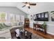 Bright living room features a vaulted ceiling, a ceiling fan, and lots of natural light at 317 Calgary Dr, Peachtree City, GA 30269