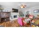 Cozy living room with a painted brick fireplace, hardwood floors, and plenty of natural light at 317 Calgary Dr, Peachtree City, GA 30269
