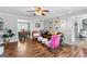 Inviting living area with hardwood floors, comfortable seating, and seamless connection to the dining room at 317 Calgary Dr, Peachtree City, GA 30269