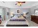 Comfortable main bedroom featuring a cozy bed, ceiling fan, and ample natural light at 317 Calgary Dr, Peachtree City, GA 30269