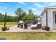 Backyard patio featuring stylish outdoor seating, a charming fire pit, and elegant string lights for relaxation at 317 Calgary Dr, Peachtree City, GA 30269