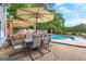 Covered patio area with outdoor dining set, ideal for entertaining beside the inviting pool at 317 Calgary Dr, Peachtree City, GA 30269