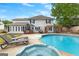 Backyard with a large in-ground pool, hot tub, and patio area, with an outdoor kitchen at 317 Calgary Dr, Peachtree City, GA 30269