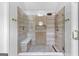 Modern shower featuring frameless glass enclosure, rainfall showerhead, bench, and mosaic tile flooring with wood look tile at 317 Calgary Dr, Peachtree City, GA 30269