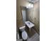 Bathroom with a tiled floor, a pedestal sink, toilet, and large mirror at 5128 Running Fox Trl, Norcross, GA 30071