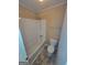 A bathroom featuring a toilet, bathtub and shower combination, and a handheld shower at 5128 Running Fox Trl, Norcross, GA 30071