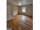 An interior view of a bedroom featuring beautiful hardwood floors, a ceiling fan, and a window at 5128 Running Fox Trl, Norcross, GA 30071