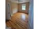Bedroom featuring hardwood floors, a ceiling fan, a window, and a closet at 5128 Running Fox Trl, Norcross, GA 30071