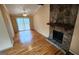 Bright living room with hardwood floors and a stone fireplace with sliding glass doors to a deck at 5128 Running Fox Trl, Norcross, GA 30071