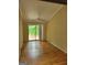Bright living room featuring wood floors and sliding glass doors leading to an outdoor deck at 5128 Running Fox Trl, Norcross, GA 30071