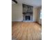 Bright living room with a stone fireplace, hardwood floors and a window at 5128 Running Fox Trl, Norcross, GA 30071