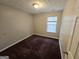 Cozy bedroom with neutral walls, plush carpeting, and a bright window with natural light at 6206 Flat Trace, South Fulton, GA 30291