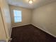 Cozy bedroom with neutral walls, plush carpeting, and a bright window with natural light at 6206 Flat Trace, South Fulton, GA 30291