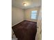 Cozy bedroom with neutral walls, plush carpeting, and a bright window with natural light at 6206 Flat Trace, South Fulton, GA 30291