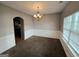 Traditional dining room featuring a chandelier, wainscoting, neutral walls, and large window at 6206 Flat Trace, South Fulton, GA 30291