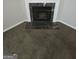 Close-up of a living room fireplace with a marble surround and dark brown carpeting at 6206 Flat Trace, South Fulton, GA 30291