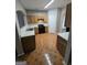 A kitchen with black appliances, wooden cabinets, and tile floors with an arched doorway at 6206 Flat Trace, South Fulton, GA 30291
