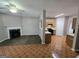 Open-concept living room with a fireplace, and access to the kitchen with dark brown flooring at 6206 Flat Trace, South Fulton, GA 30291