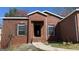 Close-up view of a classic brick home with a welcoming entryway and windows with shutters at 8828 Patricia Rose, Douglasville, GA 30134