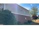 Side view of brick and gray siding of home with an air conditioning unit and partial blue sky in the background at 8828 Patricia Rose, Douglasville, GA 30134
