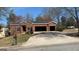 Charming brick home featuring a two-car garage and well-maintained lawn at 8828 Patricia Rose, Douglasville, GA 30134