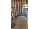 Under construction living room features concrete flooring and exposed framing at 8828 Patricia Rose, Douglasville, GA 30134