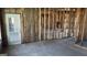 Unfinished living room showing studs and doorway, in need of repair at 8828 Patricia Rose, Douglasville, GA 30134