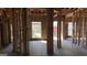 Spacious, unfinished living room showcasing exposed framing and natural light from the windows at 8828 Patricia Rose, Douglasville, GA 30134