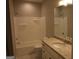 Well-lit bathroom features a granite vanity and tub with shower at 320 Sharon Dr # A & B, Fayetteville, GA 30214
