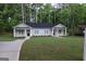 Charming single-story home with a well-manicured lawn and inviting entryway nestled amongst mature trees at 320 Sharon Dr # A & B, Fayetteville, GA 30214