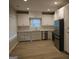 Modern kitchen featuring white cabinets, stainless steel appliances, granite countertops and luxury vinyl flooring at 320 Sharon Dr # A & B, Fayetteville, GA 30214
