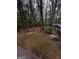 Secluded backyard with mature trees and a partially fenced yard at 150 Riversong Dr, Alpharetta, GA 30022