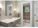 Elegant bathroom featuring marble countertop, stylish fixtures, and adjacent tiled shower at 171 Westminster Ne Dr, Atlanta, GA 30309