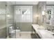 Bathroom features glass-enclosed shower and double sinks with stylish fixtures and tiled surround at 171 Westminster Ne Dr, Atlanta, GA 30309