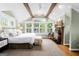 Bright bedroom featuring large windows, a fireplace, and vaulted ceilings with wooden beams at 171 Westminster Ne Dr, Atlanta, GA 30309