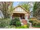 Charming bungalow exterior with brick steps, stone accents, and lush landscaping in a beautiful garden setting at 171 Westminster Ne Dr, Atlanta, GA 30309