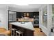 Modern kitchen features stainless steel appliances and center island with breakfast bar at 171 Westminster Ne Dr, Atlanta, GA 30309