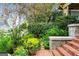 A delightful garden entrance with colorful shrubs, flowers, stone accents, and brick steps leading to the home at 171 Westminster Ne Dr, Atlanta, GA 30309